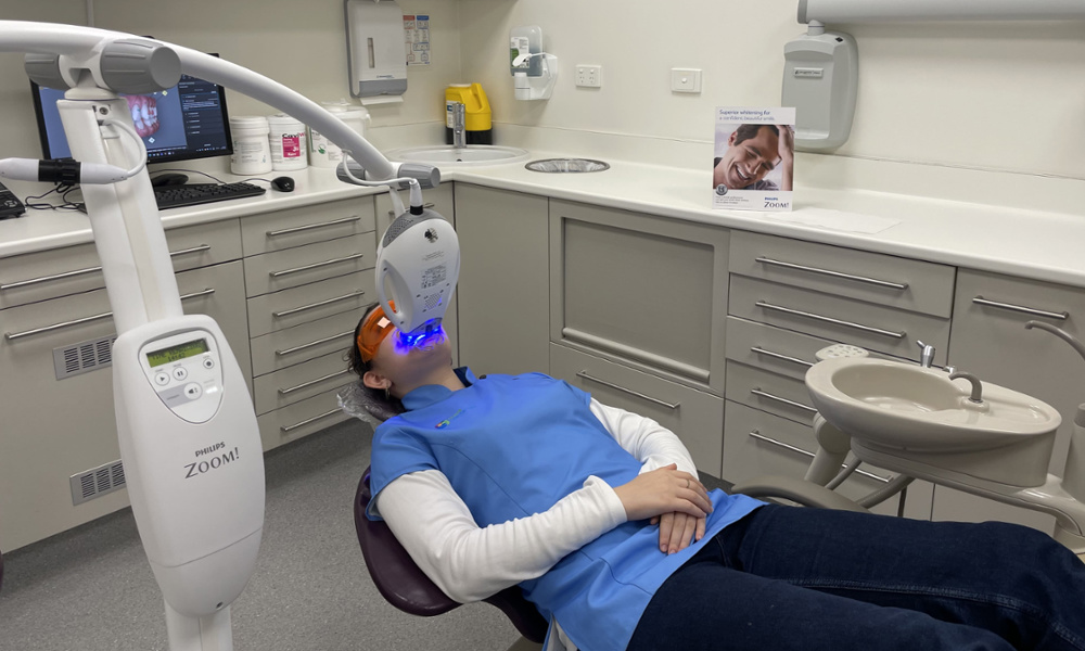 patient laying in dentist exam chair | teeth whitening everton park qld